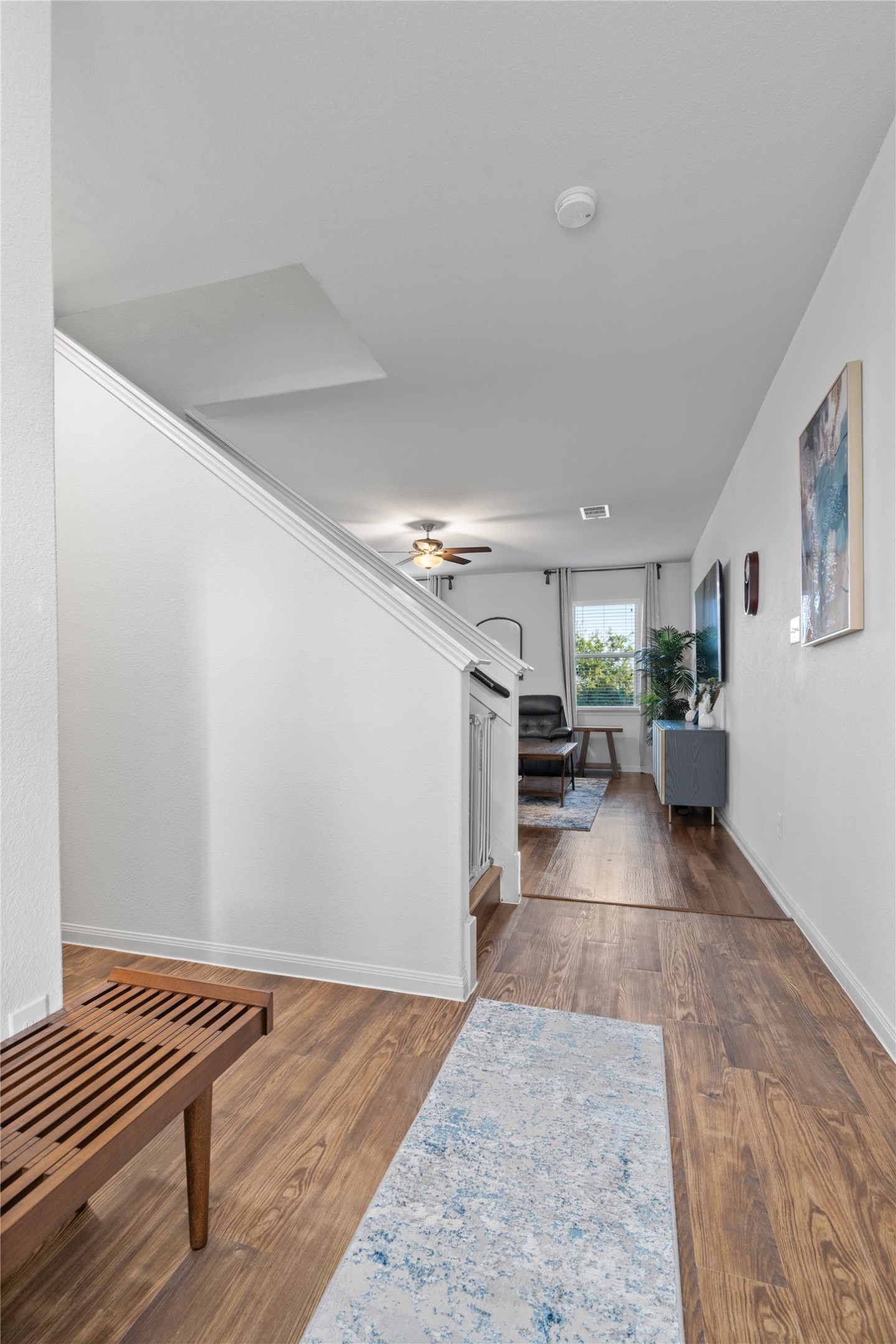 20205 Grover Cleveland Way Manor, TX 78653 - Photo 5 of 26 a view of a hallway with wooden floor and furniture