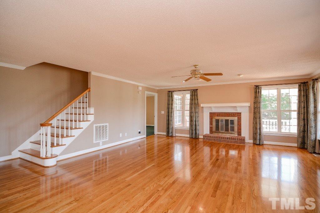 9798 Covered Bridge Road Zebulon, NC 27597 - Photo 6 of 25 Gleaming hardwood floors and wood burning fireplace.