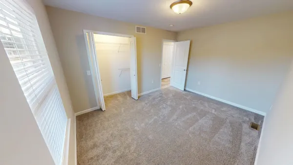 a view of an empty room with windows