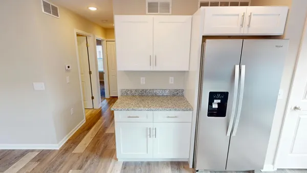 a kitchen with a refrigerator and a stove