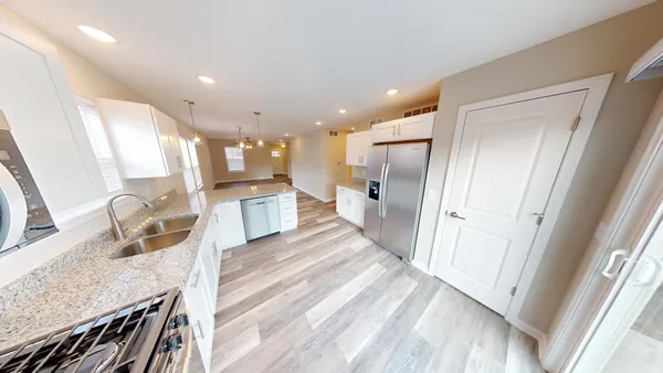 a bathroom with a granite countertop sink a mirror and shower