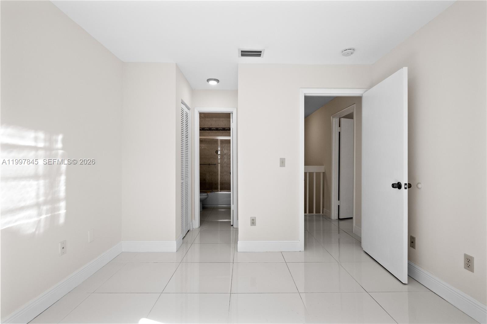 6211 Southwest 138th Court, Unit B Miami, FL 33183 - Photo 25 of 27 a view of an empty room with closet and a bathroom