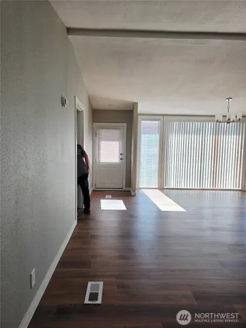 a view of an empty room with wooden floor