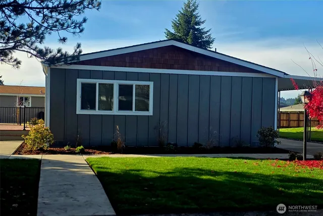 a couple of potted plants in front of door with wooden fence