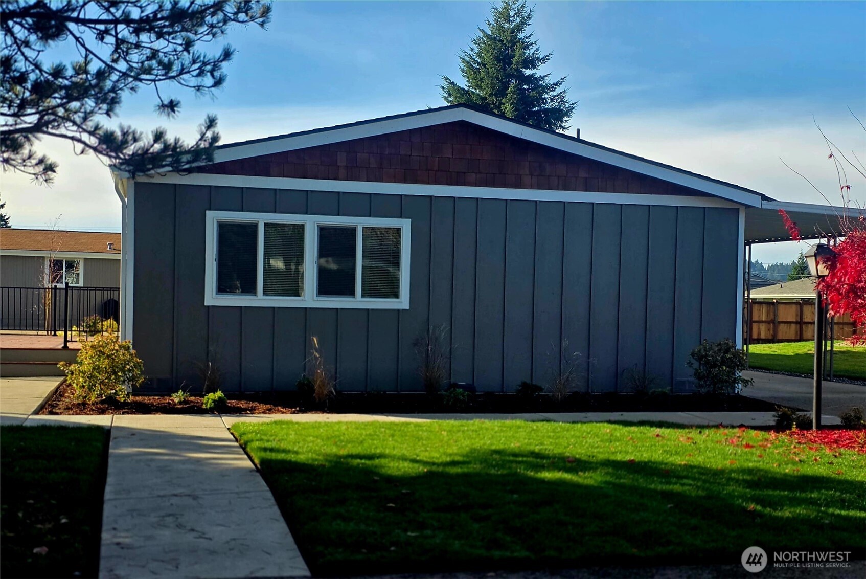 836 South Harmon Way, Unit 73 Orting, WA 98360 - Photo 2 of 30 a couple of potted plants in front of door with wooden fence
