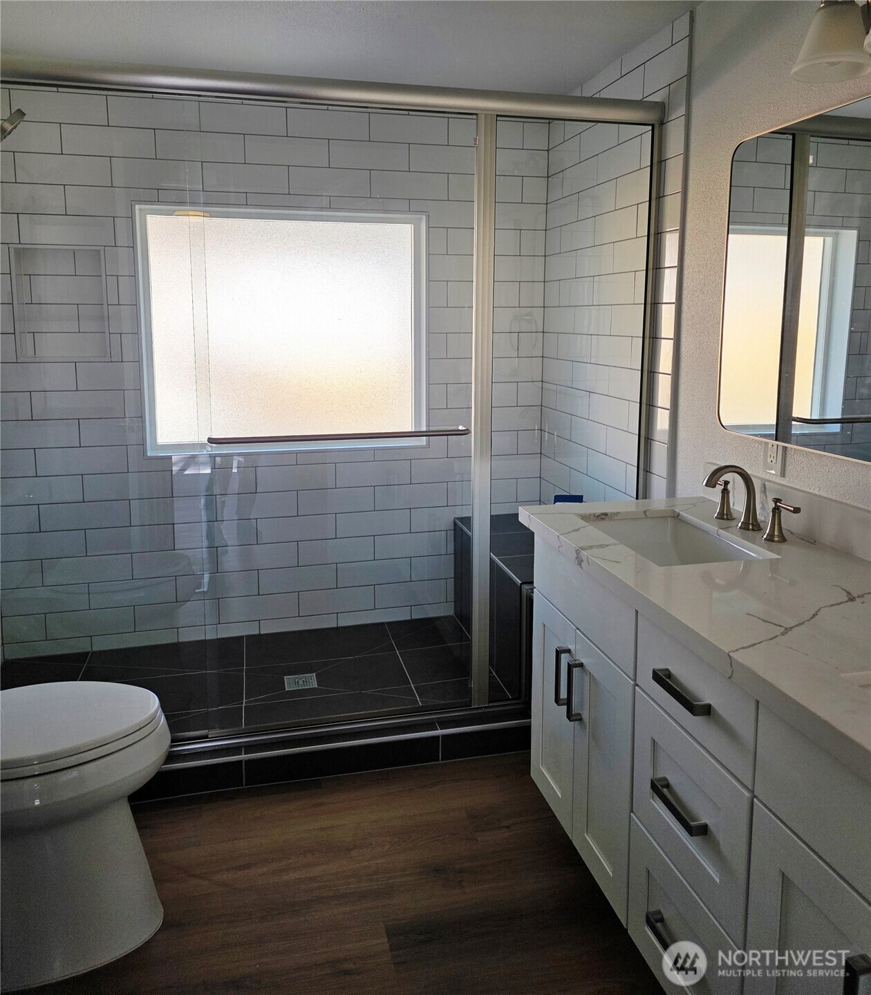 836 South Harmon Way, Unit 73 Orting, WA 98360 - Photo 23 of 30 a bathroom with a sink a toilet and a shower