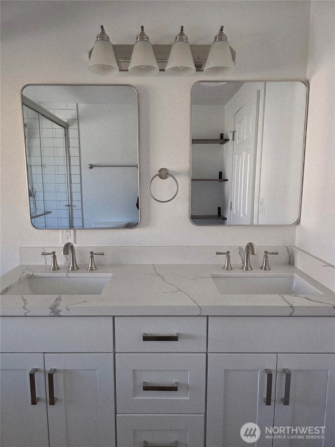 836 South Harmon Way, Unit 73 Orting, WA 98360 - Photo 24 of 30 a bathroom with a double vanity sink and mirror
