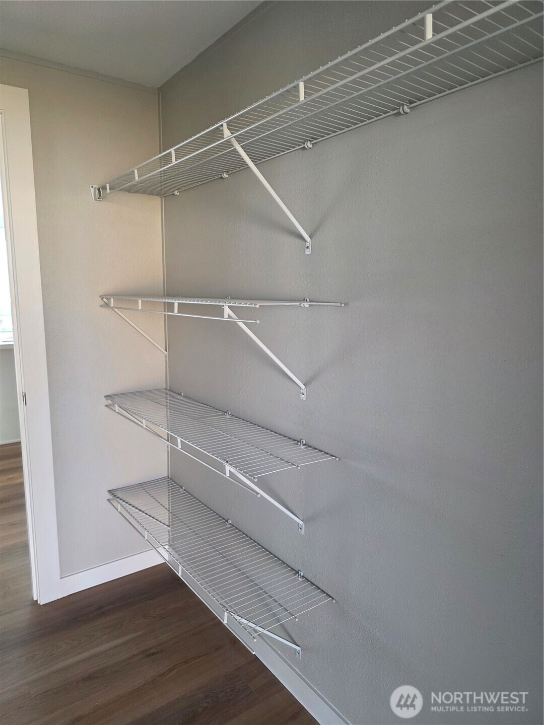 836 South Harmon Way, Unit 73 Orting, WA 98360 - Photo 26 of 30 a walk in closet with wooden floor