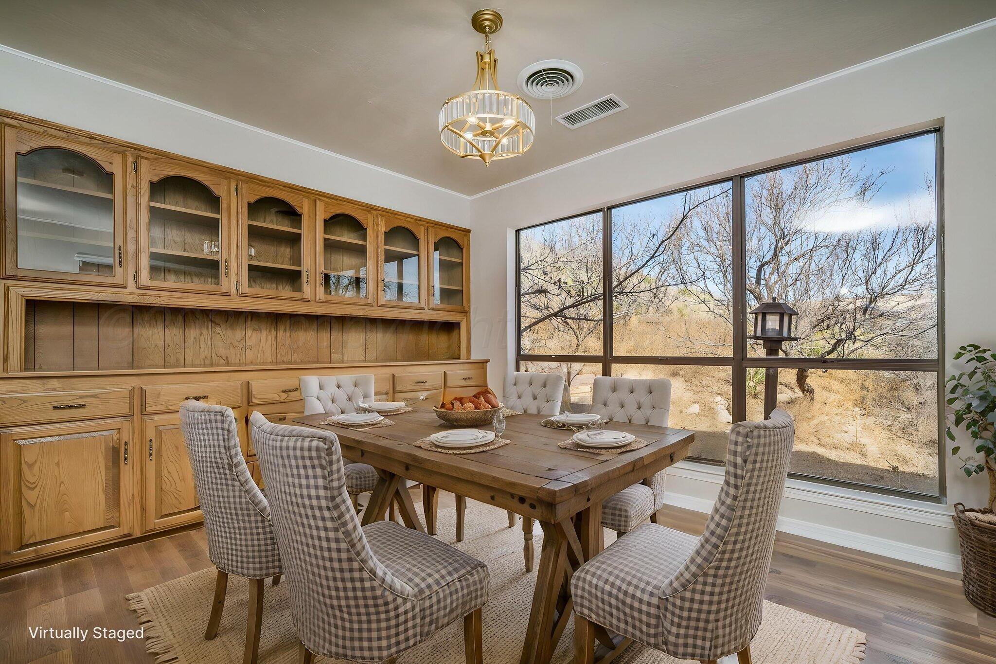 15 Lancaster Road Amarillo, TX 79124 - Photo 15 of 59 a view of a dining room with furniture large windows and wooden floor