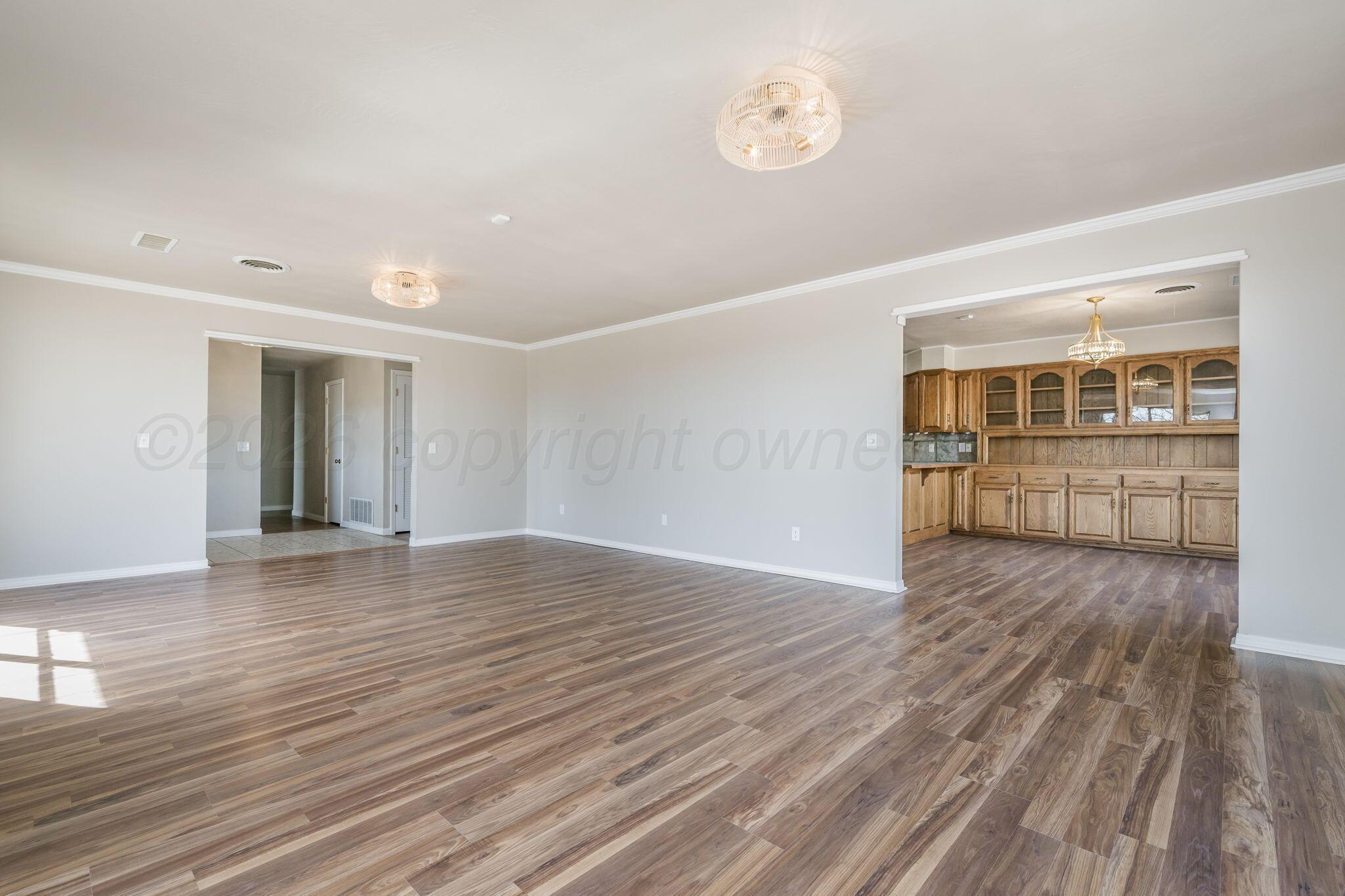 15 Lancaster Road Amarillo, TX 79124 - Photo 16 of 59 a view of empty room with wooden floor and fan