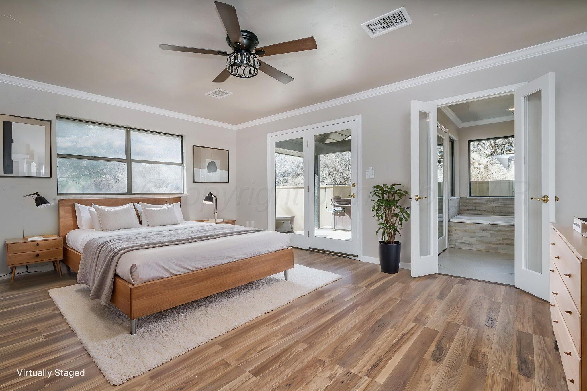 15 Lancaster Road Amarillo, TX 79124 - Photo 21 of 59 a spacious bedroom with a large bed and a chandelier