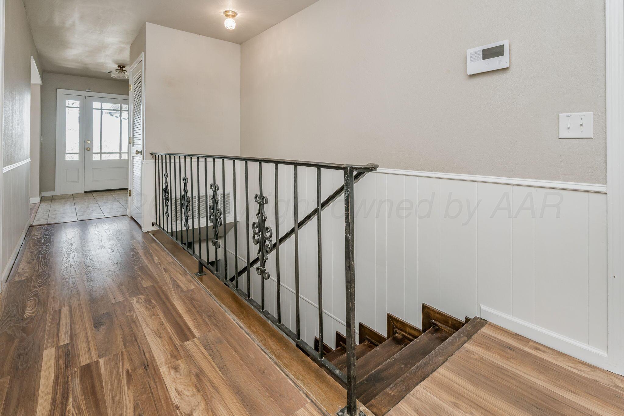 15 Lancaster Road Amarillo, TX 79124 - Photo 39 of 59 a view of a hallway with wooden floor and stairs