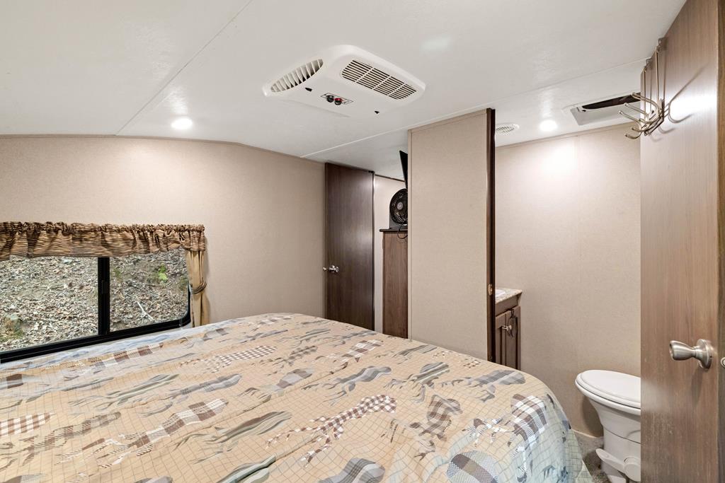 341 25th Street Ellijay, GA 30540 - Photo 11 of 15 a bedroom with a bed and a dresser