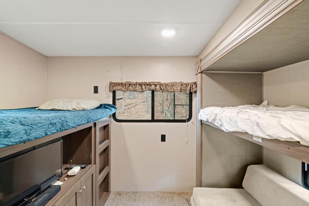 341 25th Street Ellijay, GA 30540 - Photo 12 of 15 a bathroom with a granite countertop sink and washing machine