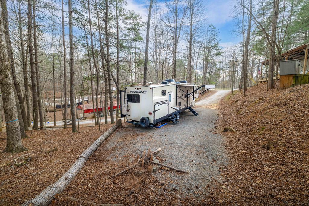 341 25th Street Ellijay, GA 30540 - Photo 15 of 15 a view of a backyard with large trees and a barn
