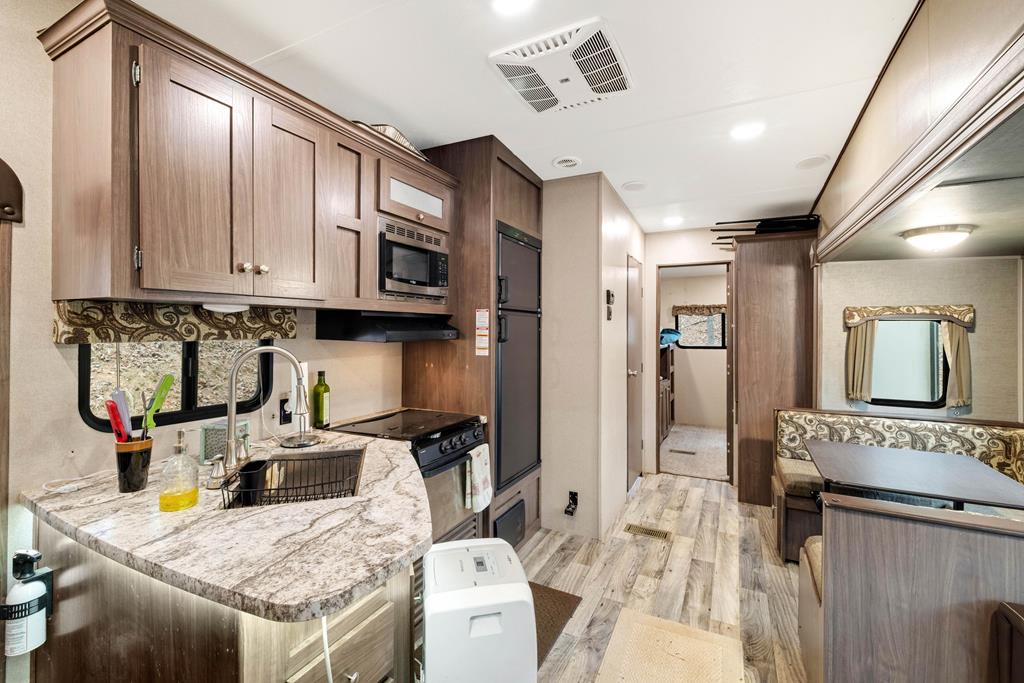 341 25th Street Ellijay, GA 30540 - Photo 6 of 15 a kitchen with granite countertop a refrigerator stove and sink