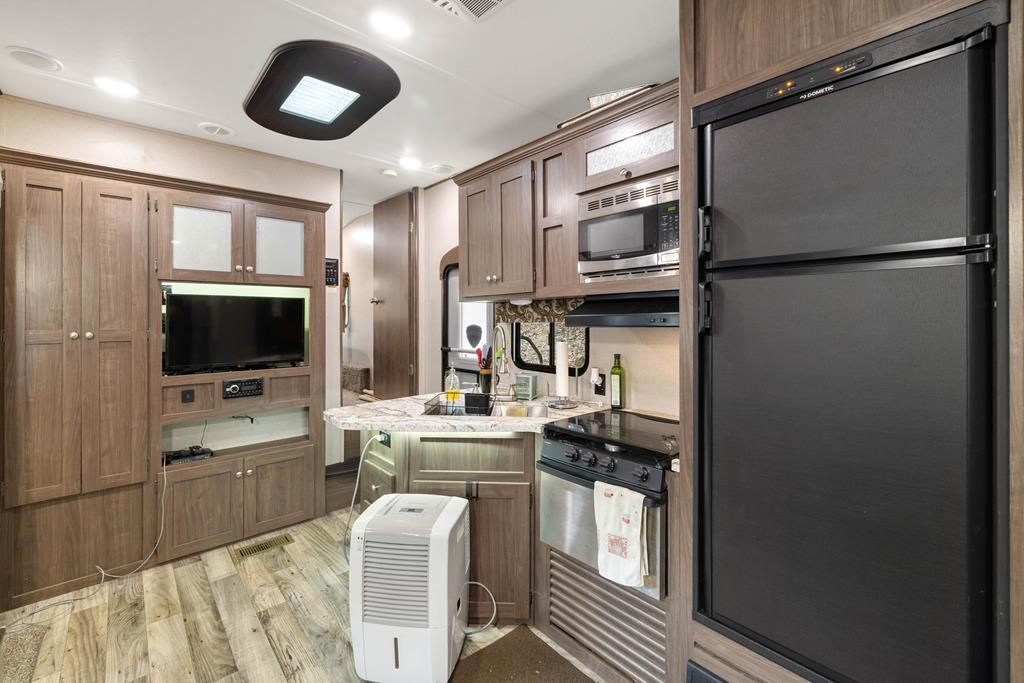 341 25th Street Ellijay, GA 30540 - Photo 7 of 15 a kitchen with stainless steel appliances a refrigerator and a stove top oven