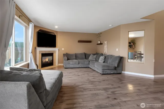 a living room with fireplace furniture and a flat screen tv