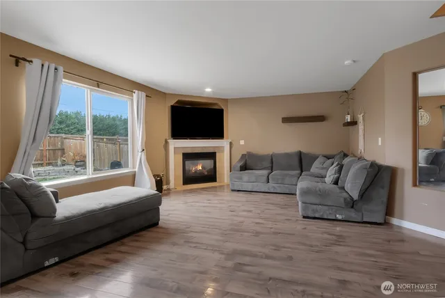 a living room with furniture flat screen tv and a fireplace
