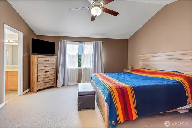 a bedroom with a bed and a television