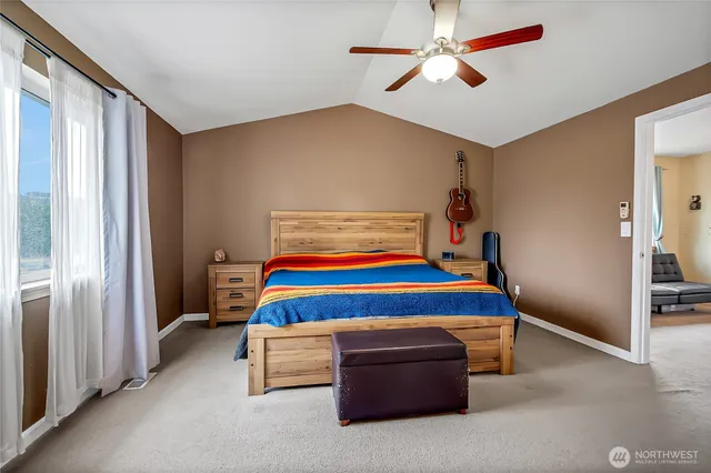 a room with pool table and ceiling fan