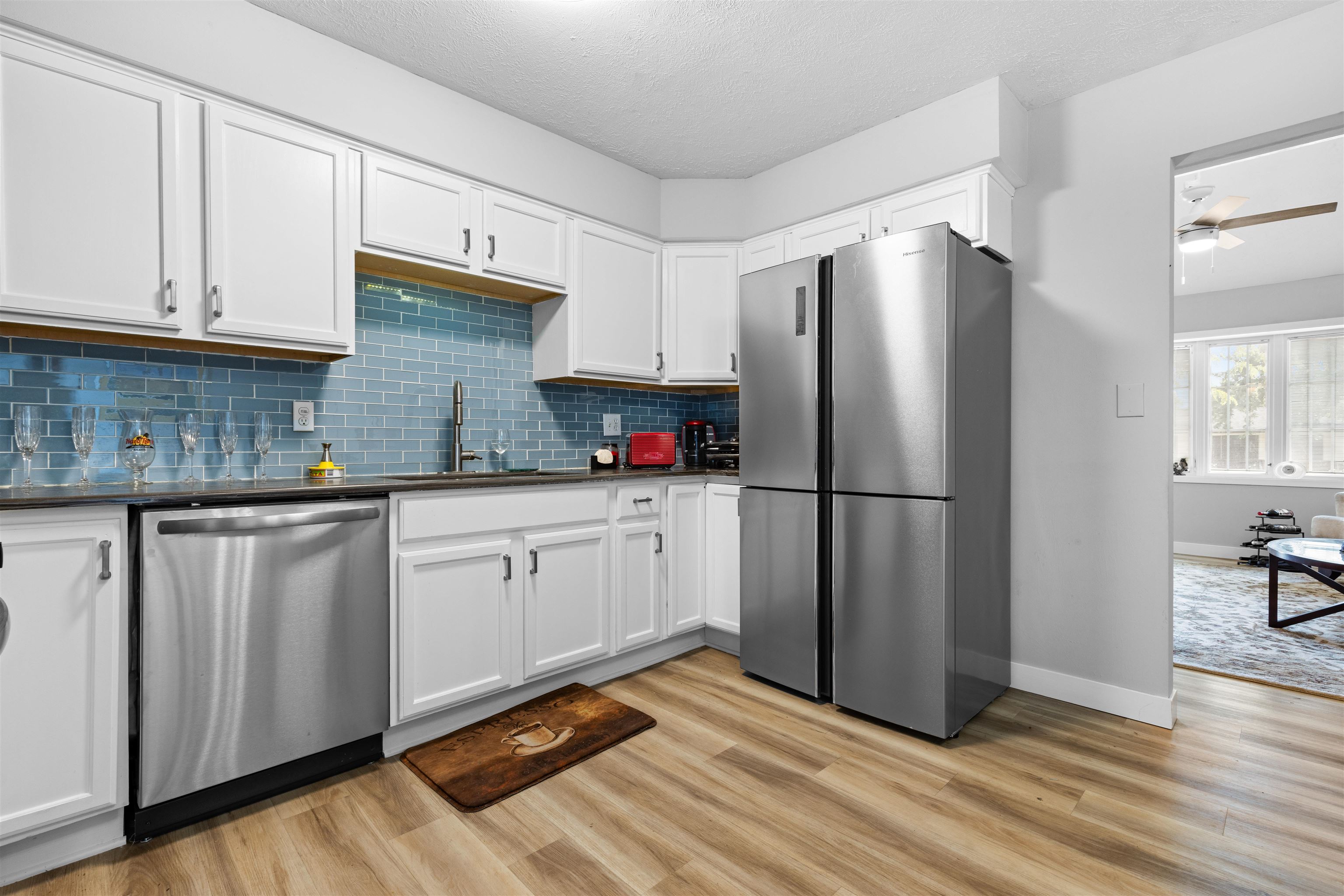 4830 Crown Point Circle Roscoe, IL 61073 - Photo 5 of 24 a kitchen with stainless steel appliances granite countertop a refrigerator sink and white cabinets