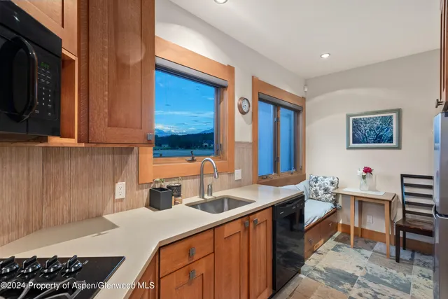 a kitchen with a sink and a stove top oven
