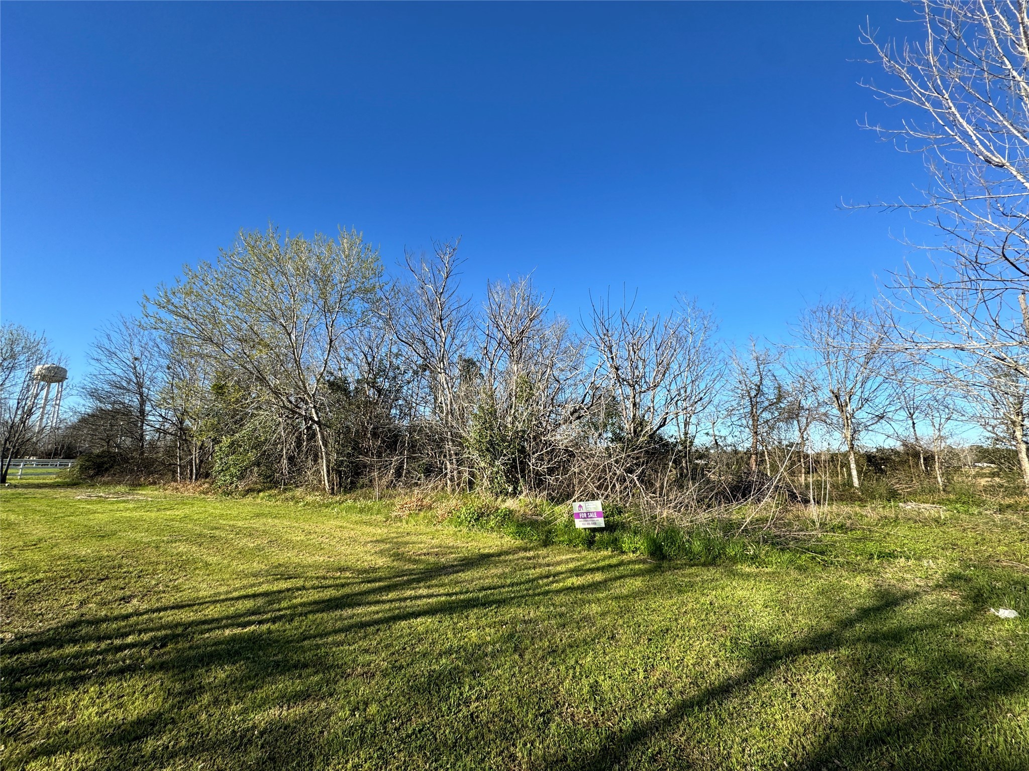 Put in gps 8602 w first st needville, tx. and to the right is a dirt road with a blue trailer. Lot is located at the end of road (Tolbert St)(No Street sign). Lot has a for sale sign and trees.