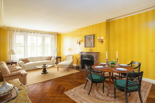 a living room with furniture a fireplace and a table