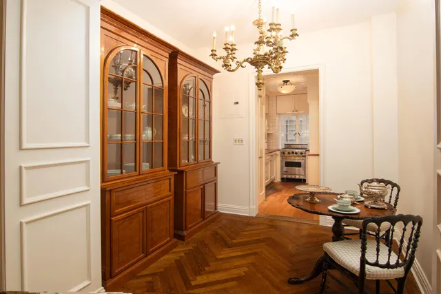 a view of a dining room with a table and chairs