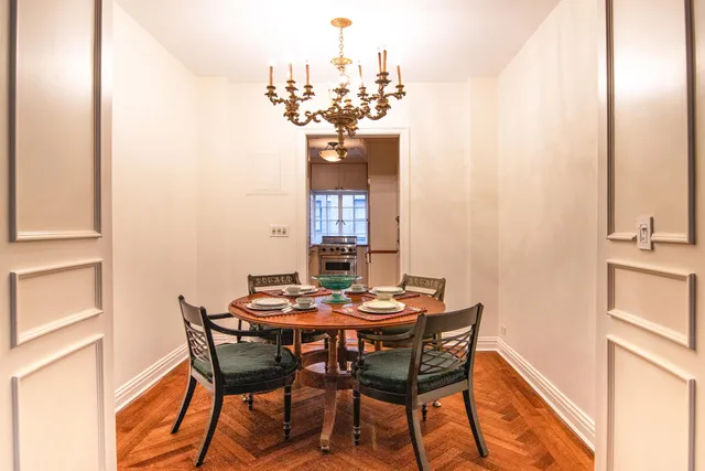 a view of a hallway to dining room and livingroom with furniture