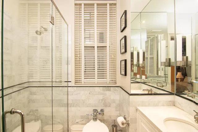 a bedroom with a bed and a book shelf