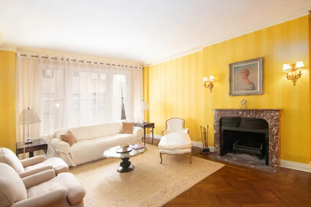 a view of a hallway with wooden floor and a bathroom