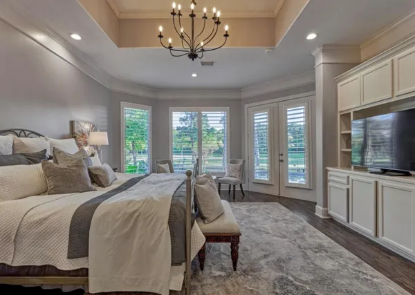 a spacious bedroom with a bed and large windows