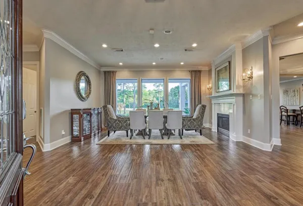 a living room with furniture a wooden floor and a large window