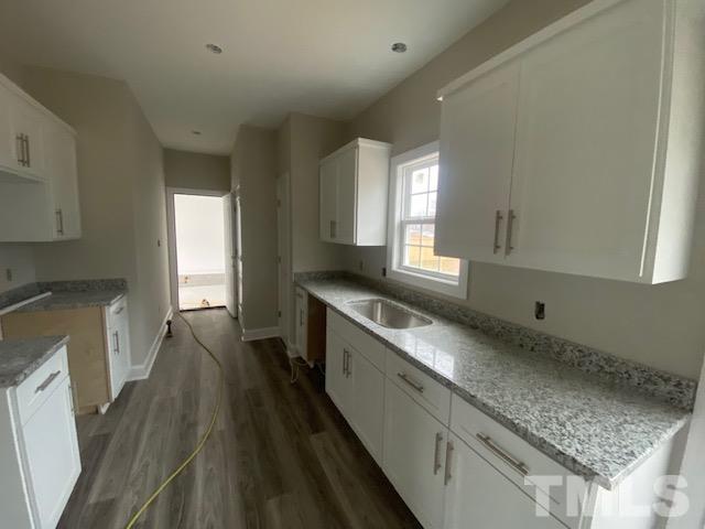 2927 Hobson Road Dunn, NC 28334 - Photo 2 of 12 a kitchen with granite countertop a sink stove and cabinets