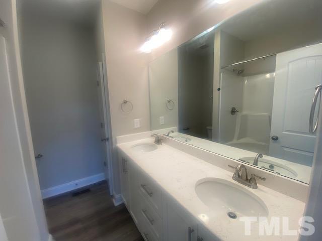 2927 Hobson Road Dunn, NC 28334 - Photo 9 of 12 a bathroom with a sink and a mirror