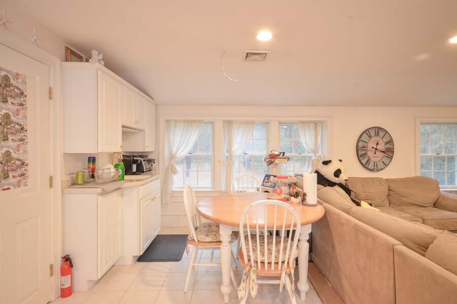 80 Farm Valley Road Osterville, MA 02655 - Photo 34 of 47 a dining room with furniture and a clock