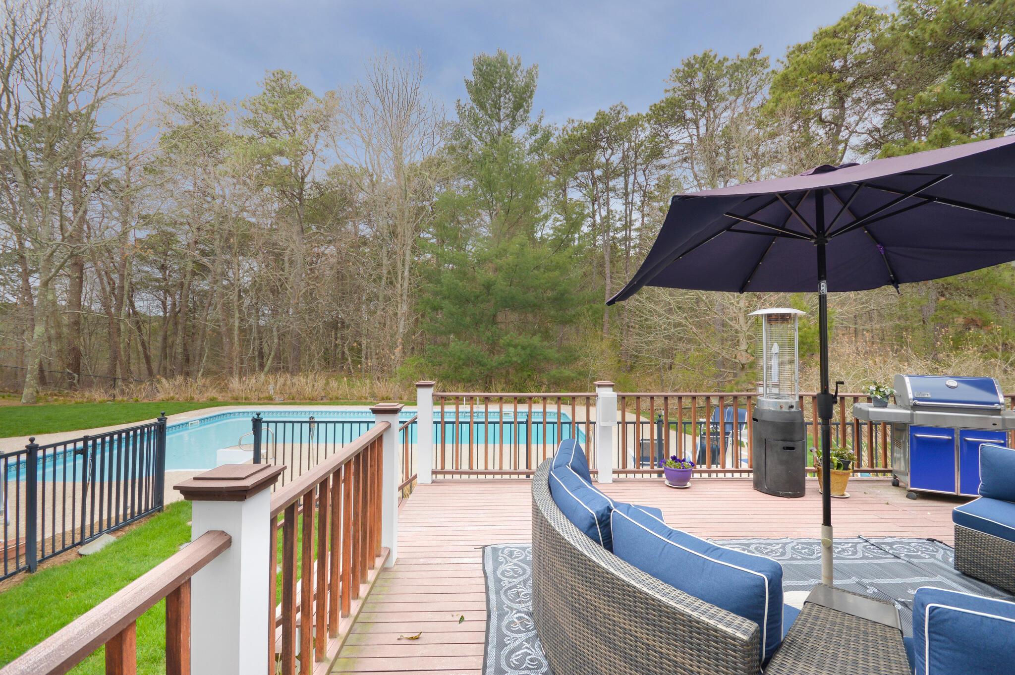80 Farm Valley Road Osterville, MA 02655 - Photo 41 of 47 a view of a patio with couches under an umbrella