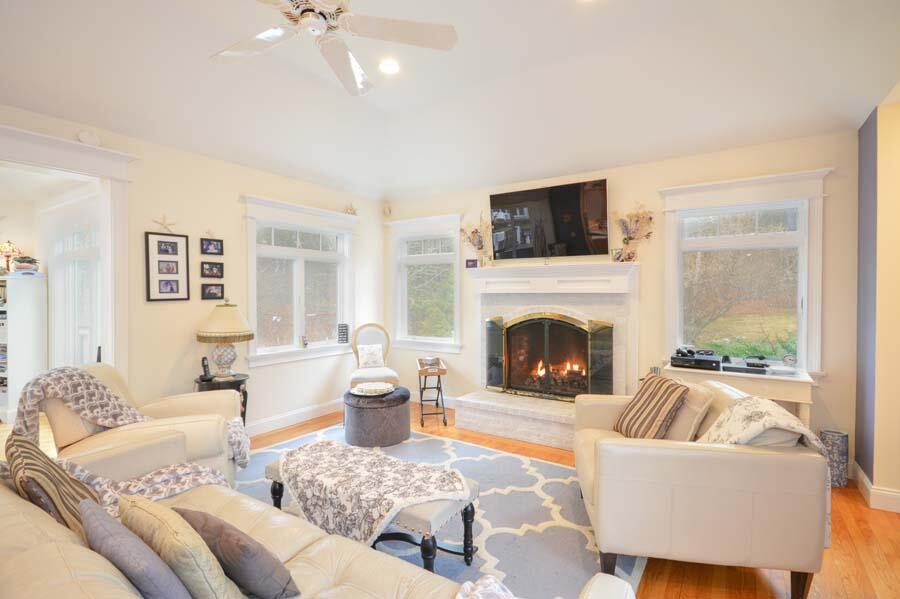 80 Farm Valley Road Osterville, MA 02655 - Photo 9 of 47 a living room with furniture and a fireplace