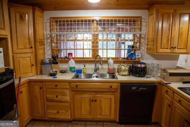 a kitchen with stainless steel appliances granite countertop a sink and a refrigerator