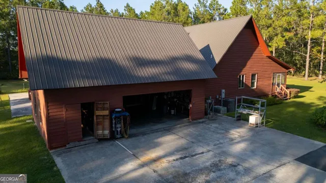 a view of a house with a patio and a yard