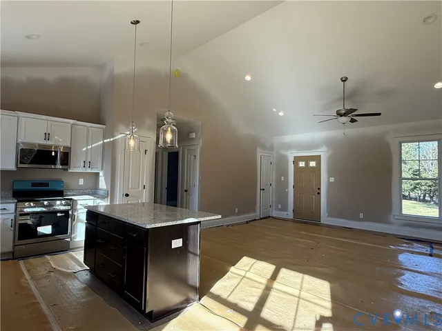 a view of a livingroom with a ceiling fan and window