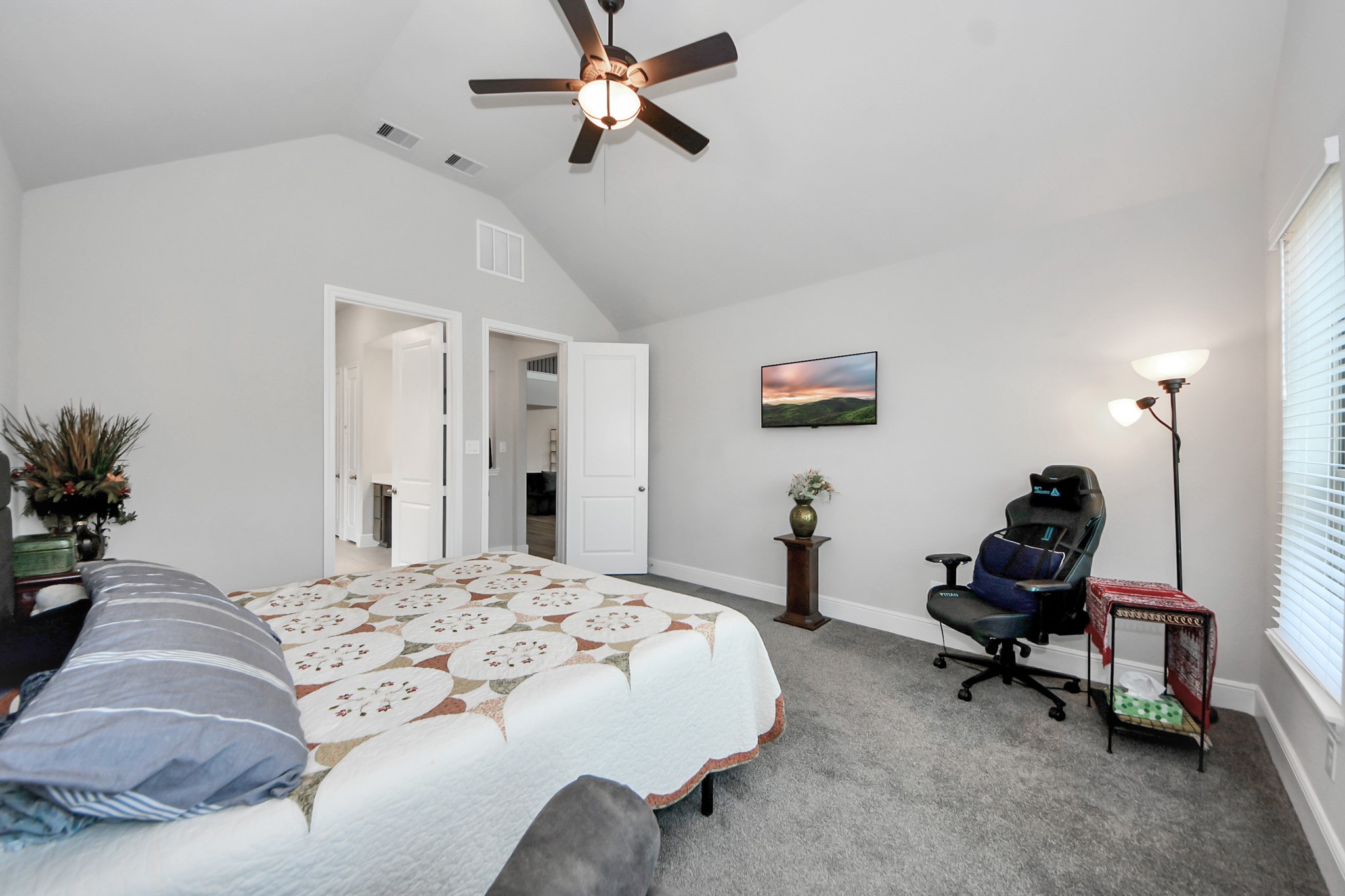 10514 Rigel Rdg Way Richmond, TX 77406 - Photo 25 of 50 a bedroom with a bed and a chandelier