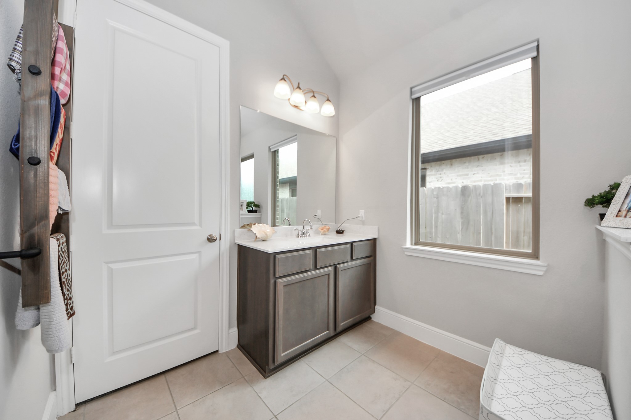 10514 Rigel Rdg Way Richmond, TX 77406 - Photo 27 of 50 a bathroom with a double vanity sink a mirror and a bathtub