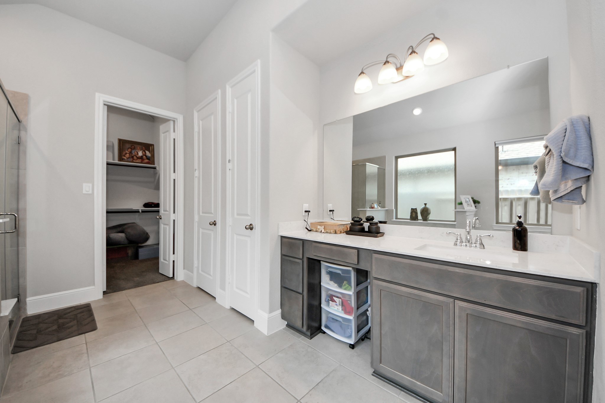 10514 Rigel Rdg Way Richmond, TX 77406 - Photo 28 of 50 a spacious bathroom with a double vanity sink a mirror and a shower