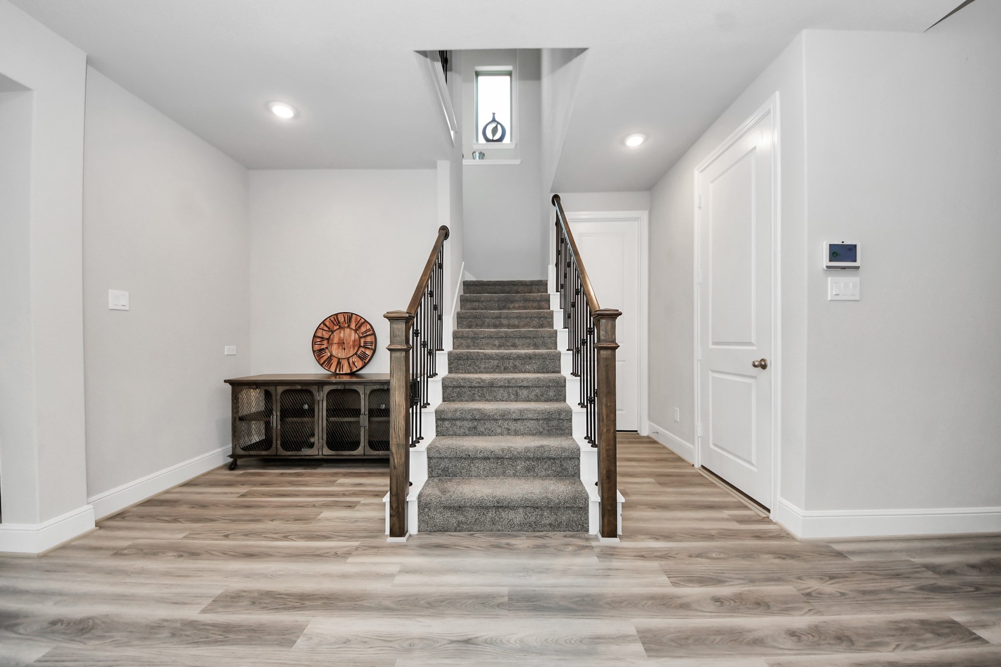 10514 Rigel Rdg Way Richmond, TX 77406 - Photo 31 of 50 a view of a hallway with wooden floor and white walls