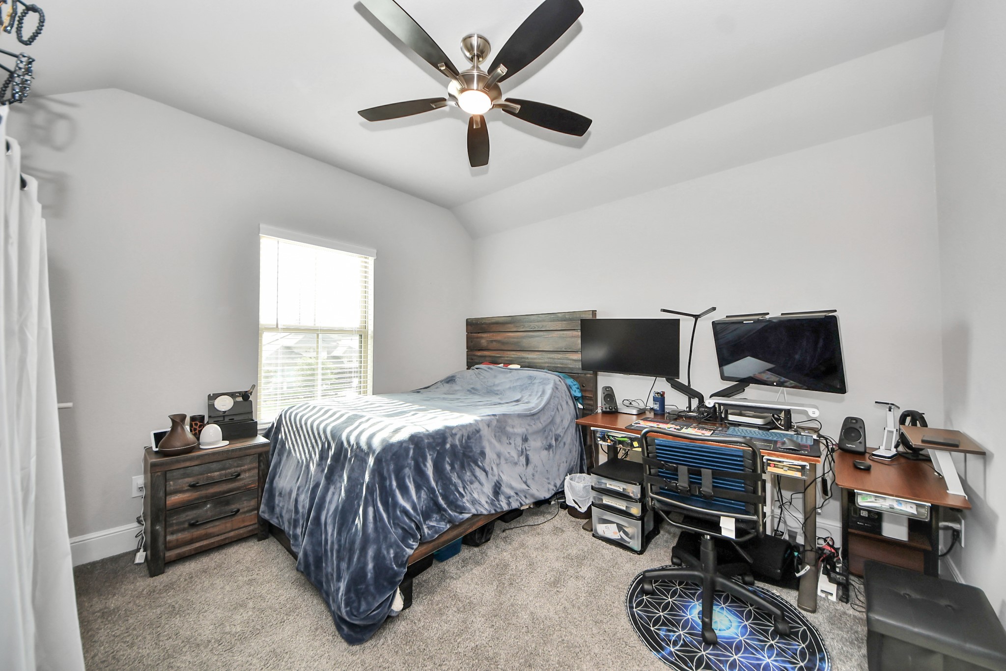 10514 Rigel Rdg Way Richmond, TX 77406 - Photo 39 of 50 a bedroom with a bed and a chandelier