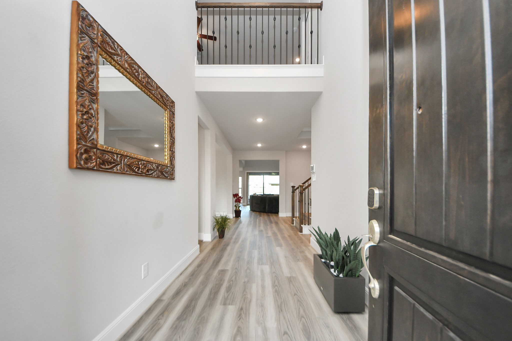 10514 Rigel Rdg Way Richmond, TX 77406 - Photo 4 of 50 a view of a hallway with wooden floor and staircase