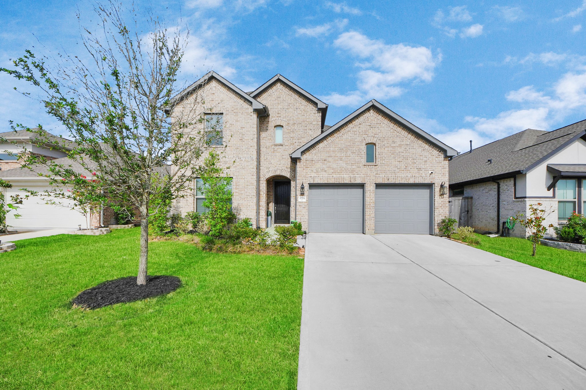 10514 Rigel Rdg Way Richmond, TX 77406 - Photo 45 of 50 a front view of a house with a yard and garage